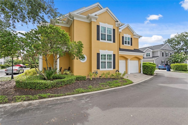 305 Sea Island Way, Tampa, FL 33602 - view of front of property featuring stucco siding, a garage, and concrete driveway