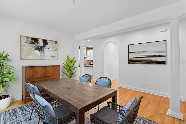 305 Sea Island Way, Tampa, FL 33602 - dining space with decorative columns and light wood-style flooring