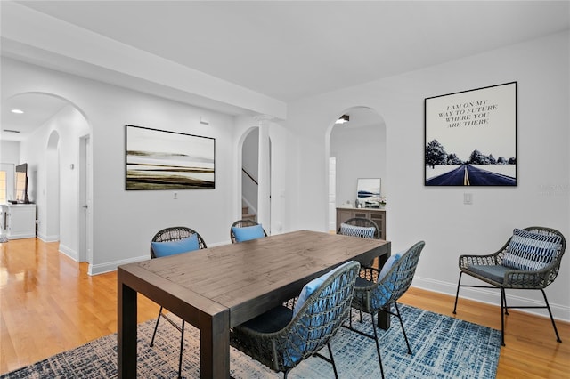 305 Sea Island Way, Tampa, FL 33602 - dining area featuring light wood-type flooring, stairway, and arched walkways