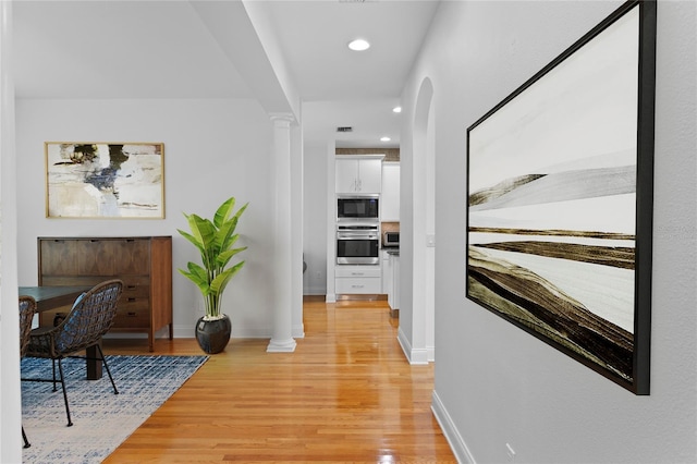 305 Sea Island Way, Tampa, FL 33602 - corridor featuring light wood-style floors, ornate columns, recessed lighting, and arched walkways