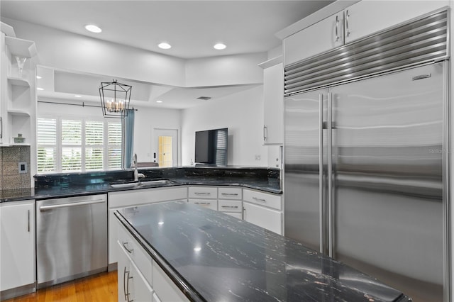 305 Sea Island Way, Tampa, FL 33602 - kitchen with stainless steel appliances, white cabinets, dark stone countertops, and recessed lighting