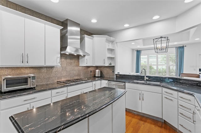 305 Sea Island Way, Tampa, FL 33602 - kitchen with wall chimney range hood, stainless steel appliances, open shelves, white cabinets, and backsplash