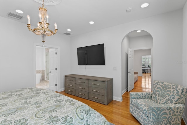 305 Sea Island Way, Tampa, FL 33602 - bedroom featuring arched walkways, light wood-style floors, recessed lighting, a chandelier, and ensuite bath