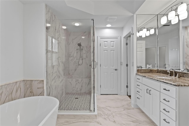 305 Sea Island Way, Tampa, FL 33602 - full bath featuring a freestanding tub, a marble finish shower, vanity, marble look tiles, and a wainscoted wall