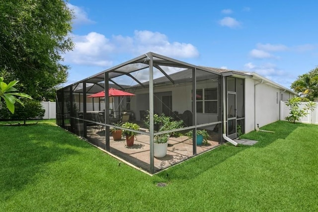 2639 Yukon Cliff Dr, Ruskin, FL 33570 - back of house with a fenced backyard, a patio area, glass enclosure, and stucco siding