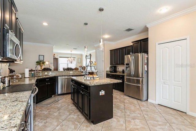 2639 Yukon Cliff Dr, Ruskin, FL 33570 - kitchen featuring appliances with stainless steel finishes, light stone counters, a chandelier, decorative light fixtures, and ornamental molding