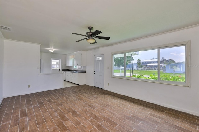 106 W N Branch Rd, Ruskin, FL 33570 - unfurnished living room featuring ceiling fan and wood finished floors