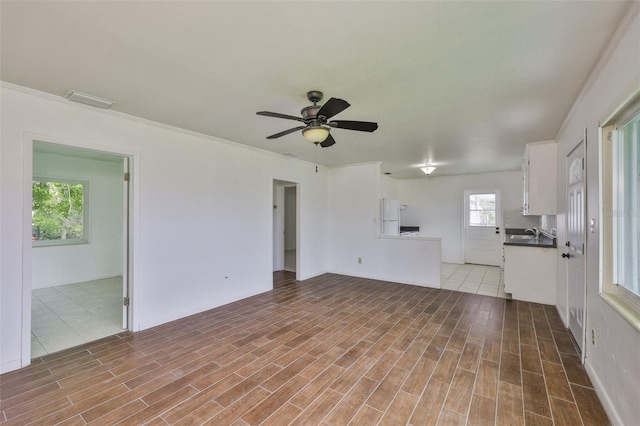106 W N Branch Rd, Ruskin, FL 33570 - unfurnished living room featuring a ceiling fan and wood finished floors