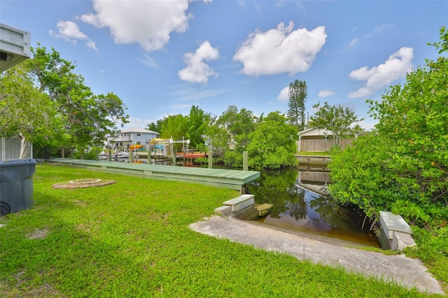 106 W N Branch Rd, Ruskin, FL 33570 - view of green lawn with a water view and a boat dock
