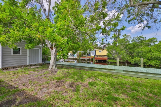 106 W N Branch Rd, Ruskin, FL 33570 - view of yard with an outbuilding, a water view, and a dock