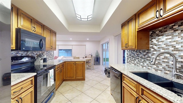 14424 Neptune Rd, Seminole, FL 33776 - kitchen featuring black appliances, tasteful backsplash, light stone counters, light tile patterned flooring, and brown cabinets