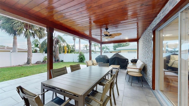 14424 Neptune Rd, Seminole, FL 33776 - fenced backyard featuring a patio, outdoor dining space, ceiling fan, and area for grilling