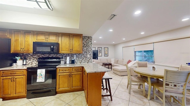 14424 Neptune Rd, Seminole, FL 33776 - kitchen featuring black appliances, brown cabinetry, tasteful backsplash, light tile patterned floors, and recessed lighting