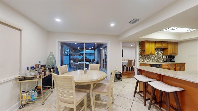 14424 Neptune Rd, Seminole, FL 33776 - dining area featuring light tile patterned flooring and recessed lighting