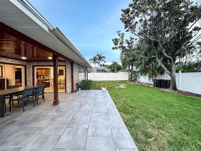 14424 Neptune Rd, Seminole, FL 33776 - fenced backyard featuring a patio area and outdoor dining space