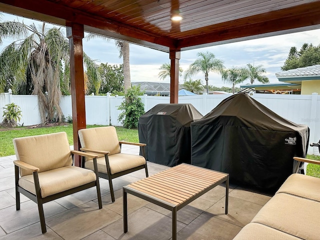 14424 Neptune Rd, Seminole, FL 33776 - fenced backyard featuring a grill and a patio