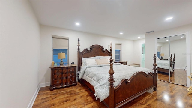 14424 Neptune Rd, Seminole, FL 33776 - bedroom with wood finished floors, recessed lighting, a closet, and ensuite bathroom