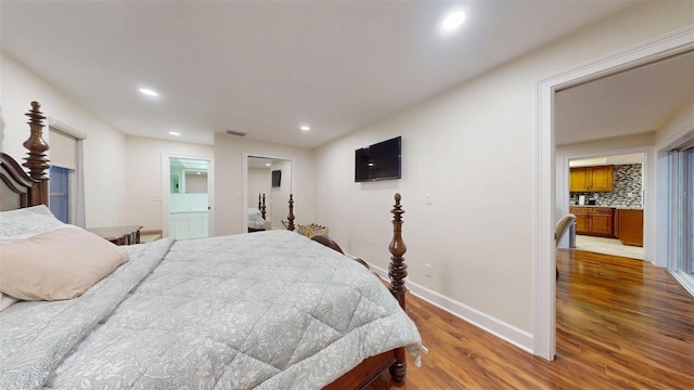 14424 Neptune Rd, Seminole, FL 33776 - bedroom with wood finished floors, recessed lighting, and connected bathroom