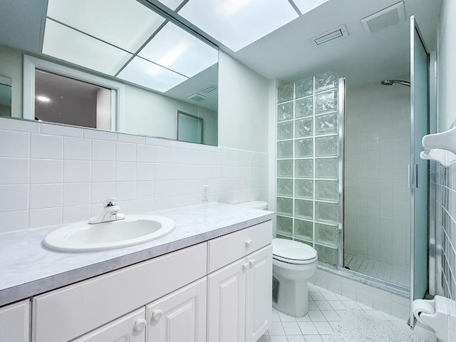 14424 Neptune Rd, Seminole, FL 33776 - bathroom with a shower stall, vanity, tile walls, tile patterned flooring, and backsplash