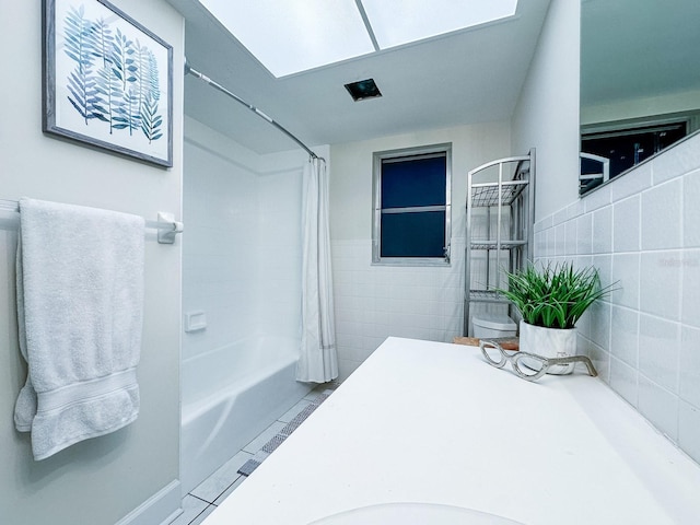 14424 Neptune Rd, Seminole, FL 33776 - bathroom with shower / tub combo and tile walls