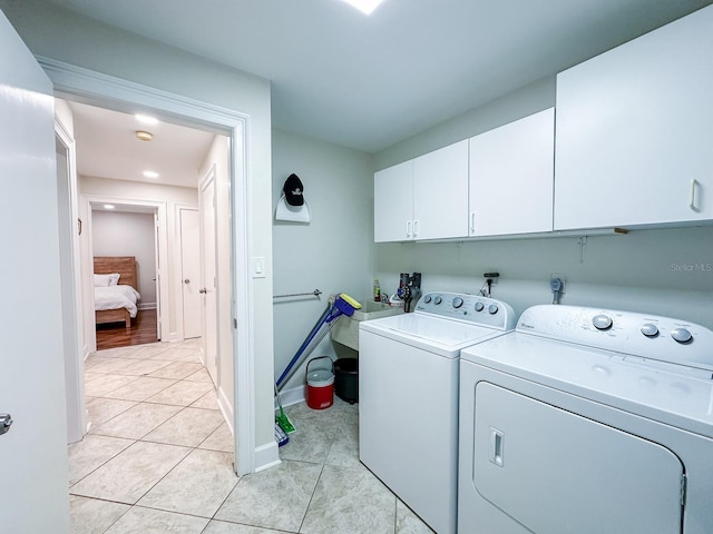14424 Neptune Rd, Seminole, FL 33776 - laundry room with cabinet space, washer and dryer, light tile patterned floors, and recessed lighting