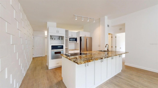 1431 Island Dr S, South Pasadena, FL 33707 - kitchen with appliances with stainless steel finishes, light wood-style floors, white cabinets, and light stone countertops
