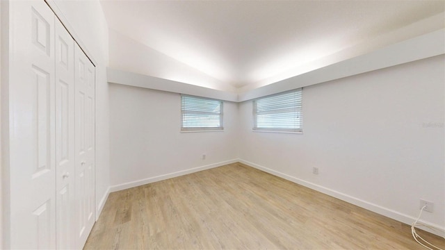 1431 Island Dr S, South Pasadena, FL 33707 - unfurnished bedroom with light wood-type flooring, a closet, and vaulted ceiling