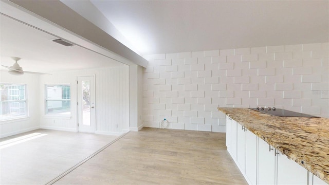 1431 Island Dr S, South Pasadena, FL 33707 - unfurnished dining area with ceiling fan, light wood-style floors, and tile walls