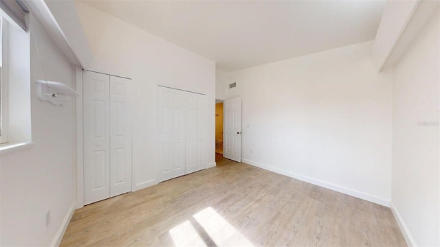 1431 Island Dr S, South Pasadena, FL 33707 - unfurnished bedroom with multiple closets and light wood finished floors