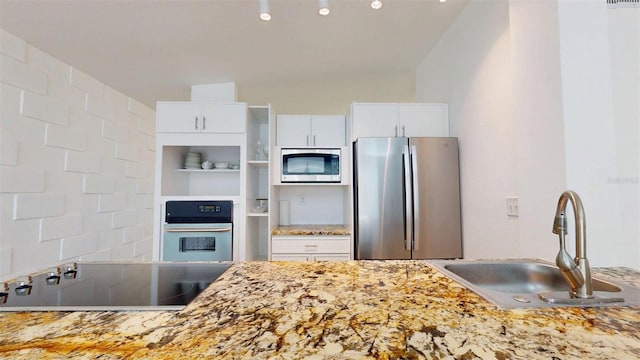 1431 Island Dr S, South Pasadena, FL 33707 - kitchen with stainless steel appliances and white cabinets