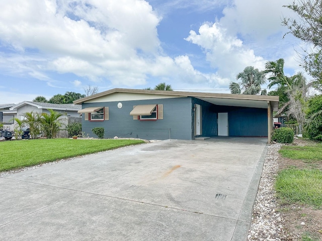 1431 Island Dr S, South Pasadena, FL 33707 - view of front of property with driveway, a front lawn, and a carport