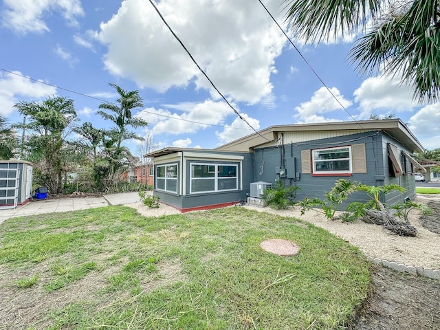 1431 Island Dr S, South Pasadena, FL 33707 - view of front facade with a front yard and a shed