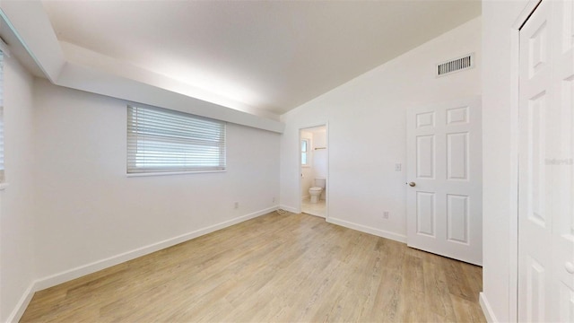 1431 Island Dr S, South Pasadena, FL 33707 - spare room featuring light wood-type flooring and vaulted ceiling