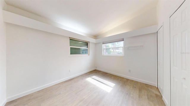 1431 Island Dr S, South Pasadena, FL 33707 - empty room with light wood-style flooring and vaulted ceiling