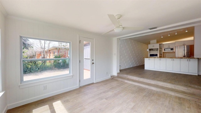 1431 Island Dr S, South Pasadena, FL 33707 - unfurnished living room with light wood-style floors and ceiling fan