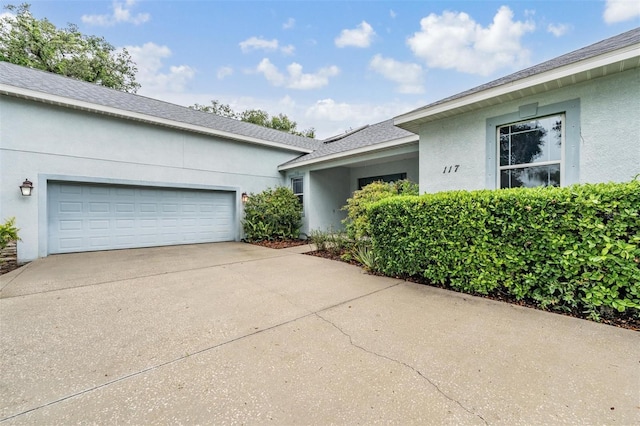 117 Camelot Ridge Dr, Brandon, FL 33511 - view of side of property with concrete driveway, stucco siding, and a garage