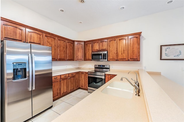 117 Camelot Ridge Dr, Brandon, FL 33511 - kitchen with stainless steel appliances, light tile patterned floors, light countertops, and brown cabinets