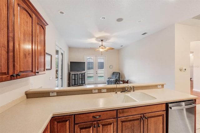 117 Camelot Ridge Dr, Brandon, FL 33511 - kitchen featuring dishwasher, a ceiling fan, light countertops, open floor plan, and brown cabinets