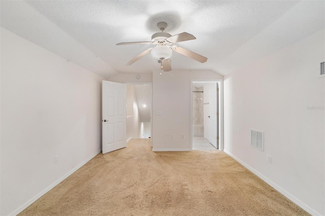 117 Camelot Ridge Dr, Brandon, FL 33511 - unfurnished bedroom featuring lofted ceiling, light carpet, a textured ceiling, connected bathroom, and ceiling fan