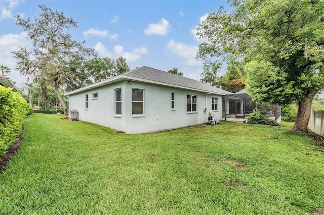 117 Camelot Ridge Dr, Brandon, FL 33511 - back of property with stucco siding, a yard, and a shingled roof