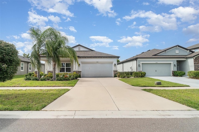 11444 Alachua Creek Ln, Riverview, FL 33579 - ranch-style home featuring a front yard, stucco siding, an attached garage, stone siding, and driveway