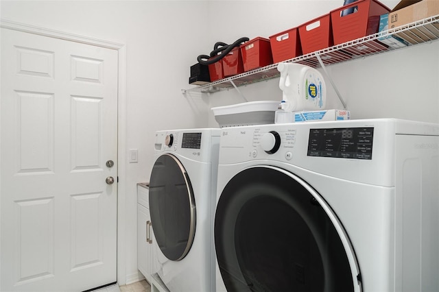 11444 Alachua Creek Ln, Riverview, FL 33579 - washroom with washing machine and clothes dryer and cabinet space