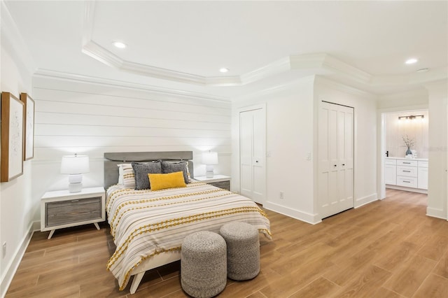 1908 Sutherland Dr W, Palm Harbor, FL 34683 - bedroom with two closets, ornamental molding, light wood-style floors, recessed lighting, and connected bathroom