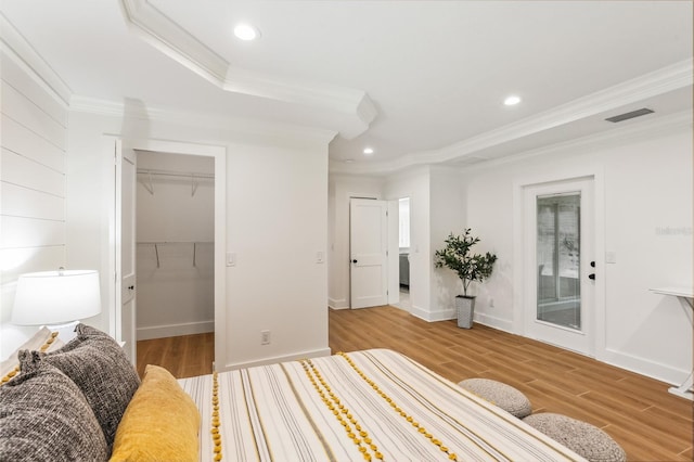 1908 Sutherland Dr W, Palm Harbor, FL 34683 - bedroom featuring ornamental molding, light wood-type flooring, recessed lighting, a spacious closet, and a closet