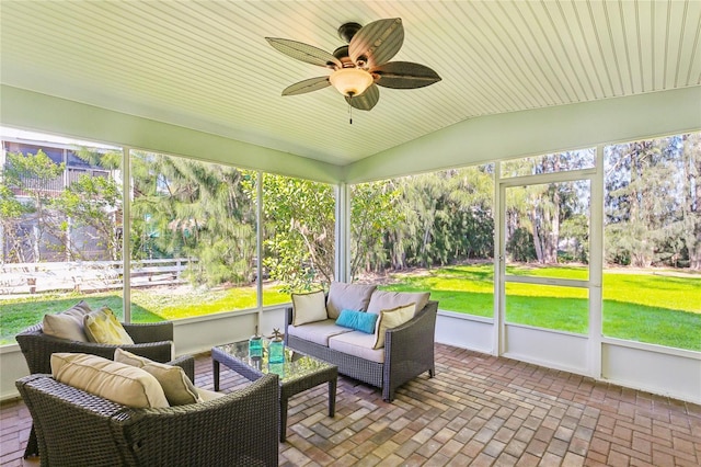 1908 Sutherland Dr W, Palm Harbor, FL 34683 - sunroom featuring an outdoor hangout area, a ceiling fan, vaulted ceiling, and healthy amount of natural light