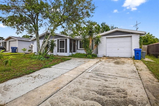 7814 Burnham Dr, Port Richey, FL 34668 - single story home with concrete driveway, a sunroom, stucco siding, and a garage