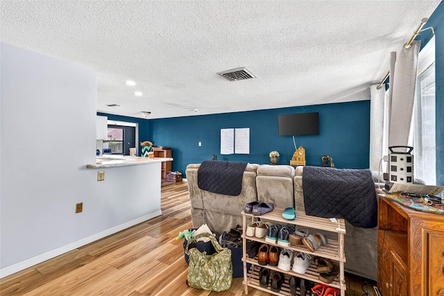 7814 Burnham Dr, Port Richey, FL 34668 - living area featuring wood finished floors and a textured ceiling