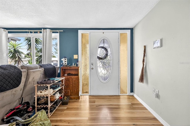 7814 Burnham Dr, Port Richey, FL 34668 - entryway with a textured ceiling, healthy amount of natural light, and wood finished floors
