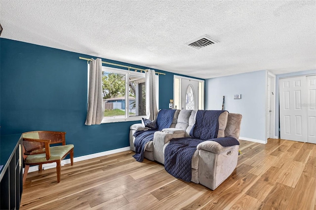 7814 Burnham Dr, Port Richey, FL 34668 - living area with light wood-type flooring and a textured ceiling