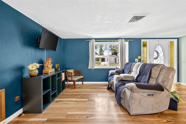 7814 Burnham Dr, Port Richey, FL 34668 - living room with a textured ceiling and wood finished floors